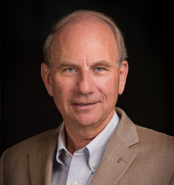 Older white man with blue eyes and blazer