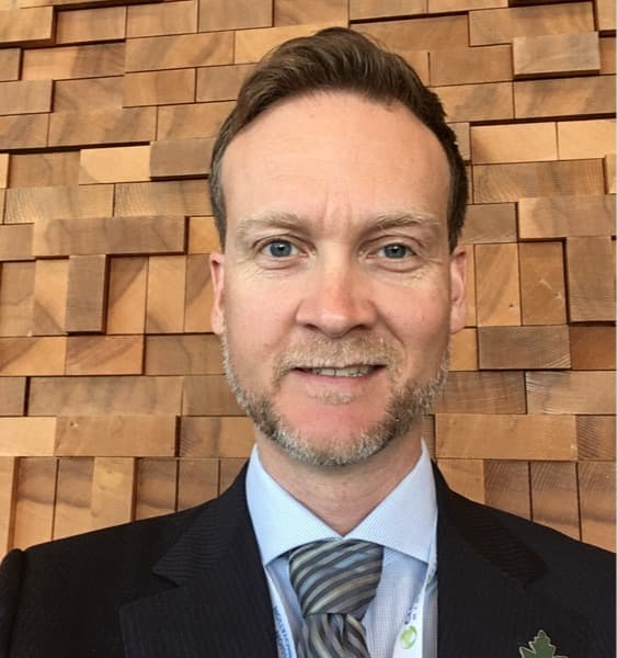 White middle aged man with a suit and tie